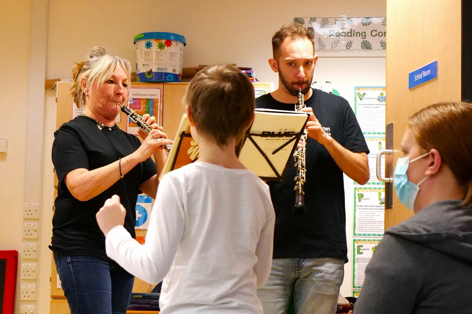 A child dances to music in a hospital classroom