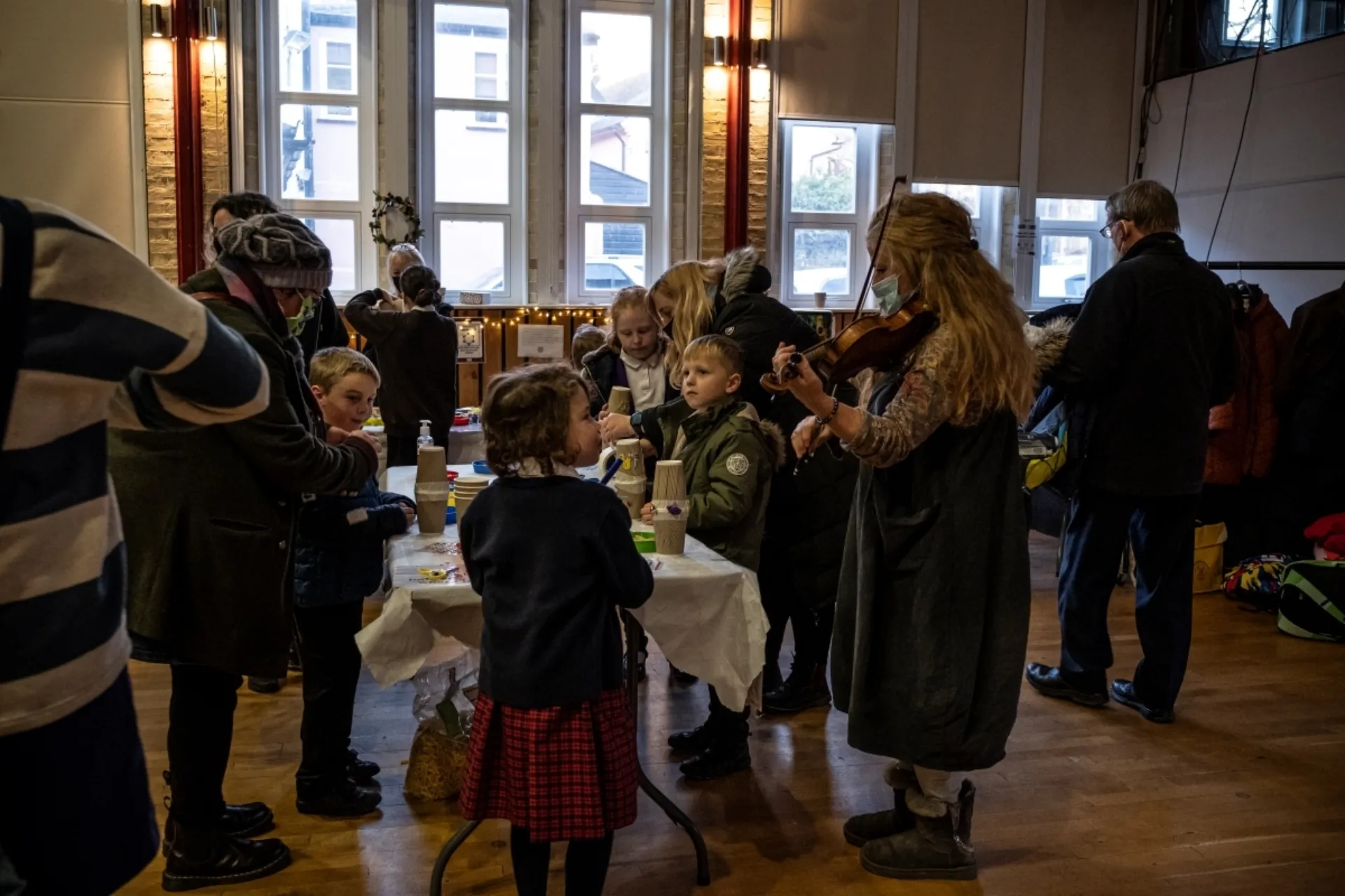 Young people making crafts and musicians playing