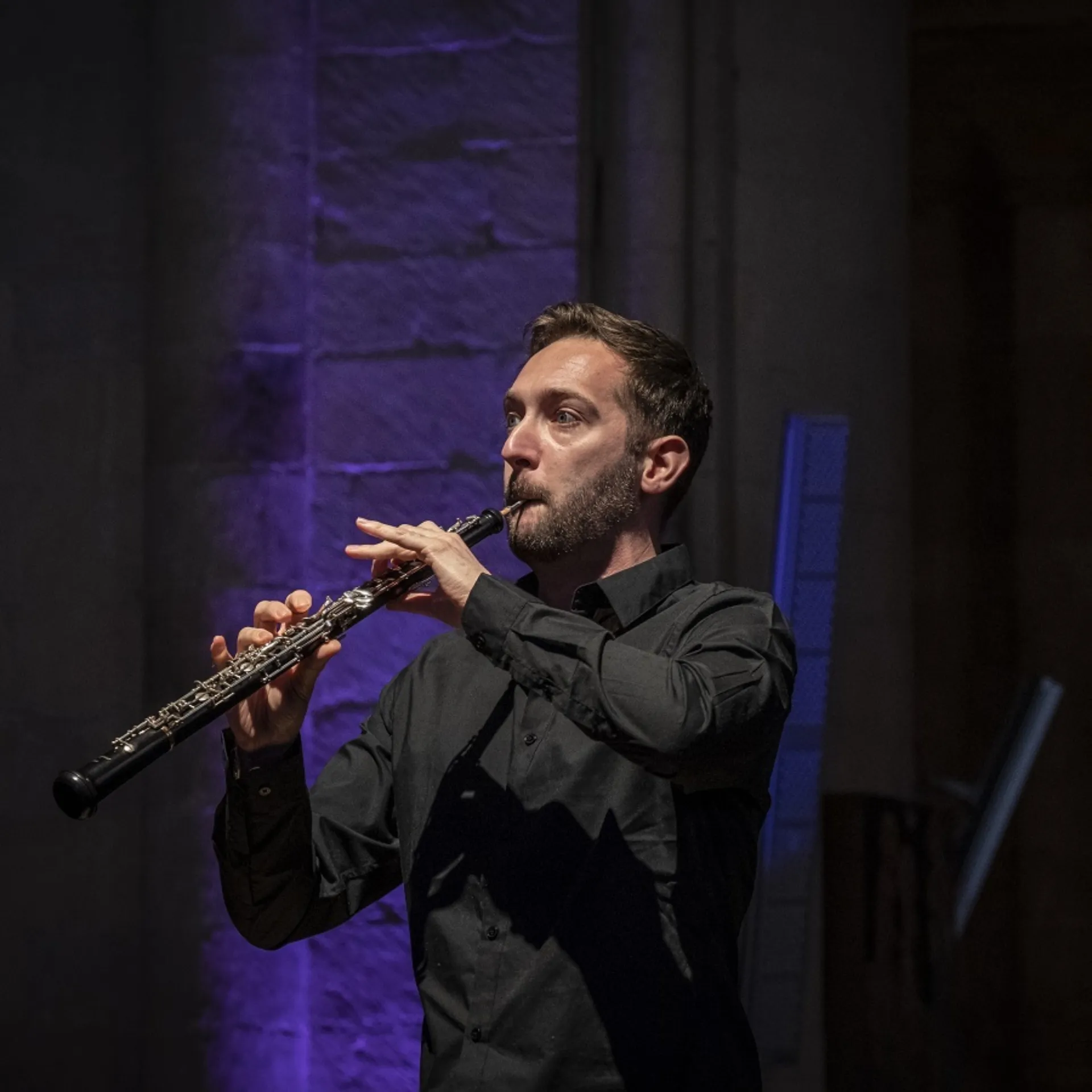 A man playing the oboe