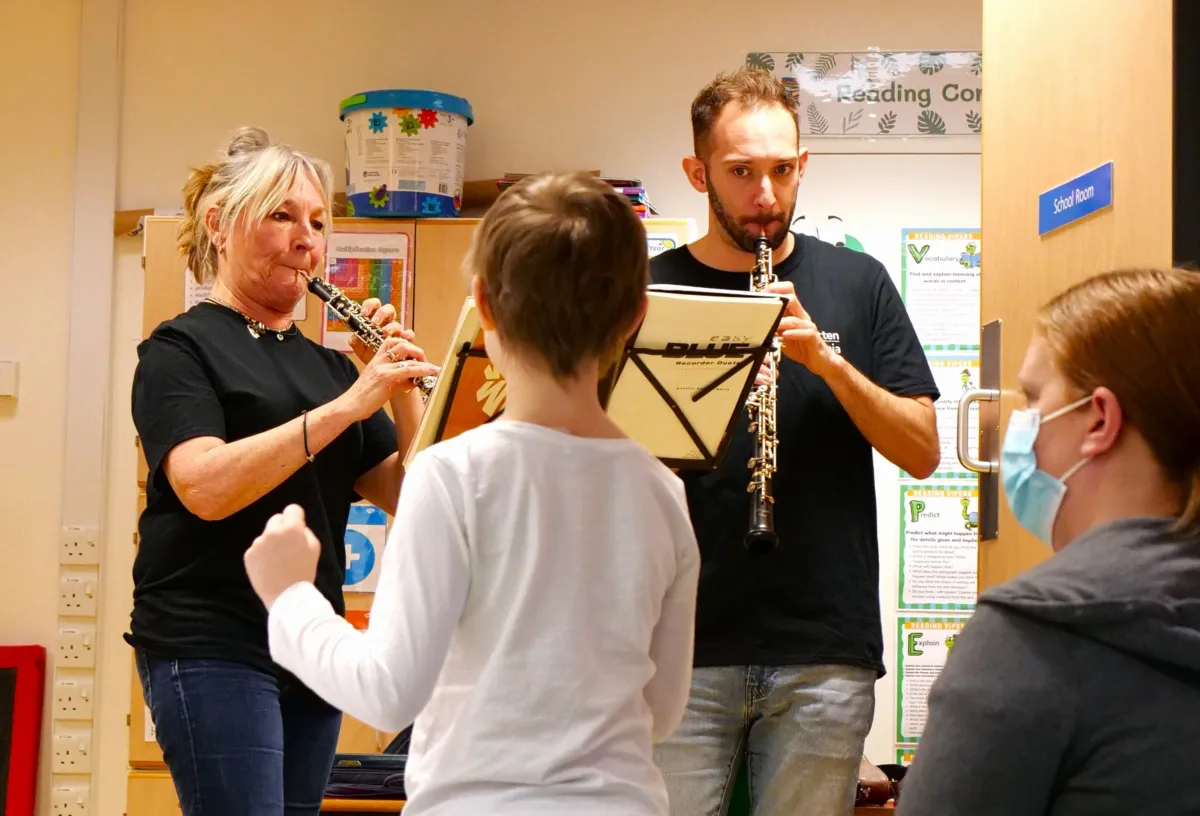 A child dances to music in a hospital classroom